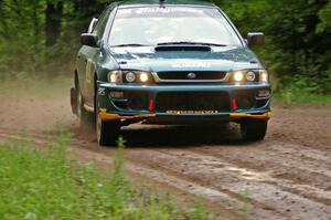 Janusz Topor / Michal Kaminski drift their Subaru Impreza through a right-sweeper on SS4.