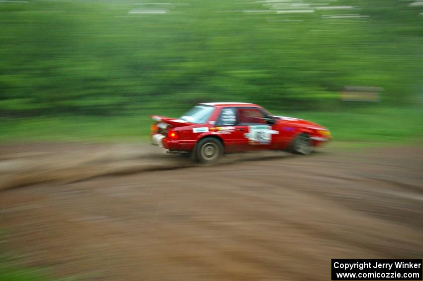 Mark Utecht / Rob Bohn drift their Ford Mustang through a sweeper in the absolute pouring rain on SS2.