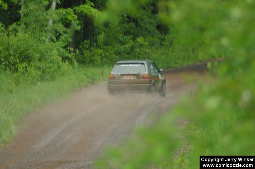 Dave Cizmas / Matt Himes drift their VW GTI into a sweeper on SS3 during a heavy rainfall.