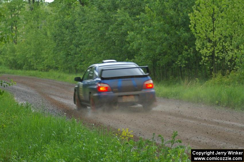 Carl Siegler / David Goodman at speed in the rain on SS3 in their Subaru WRX STi.