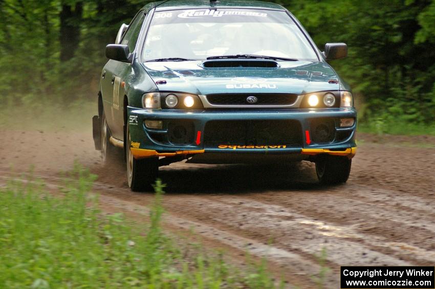 Janusz Topor / Michal Kaminski drift their Subaru Impreza through a right-sweeper on SS4.