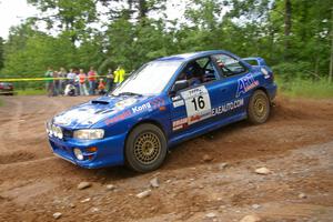 Kazimierz Pudelek / Michal Nawracaj take a hard left onto Potlatch Road in their Subaru Impreza on SS1.