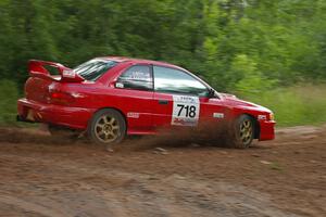 Dustin Kasten / Corina Soto make the hard left on SS1 onto Potlatch Road in their Subaru Impreza as the rain starts.