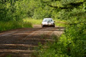 Dan Adamson / Chris Gordon at speed down a straight on SS2 in their Saturn SL2.