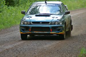 Janusz Topor / Michal Kaminski at speed down a straight on SS2 in their Subaru Impreza.