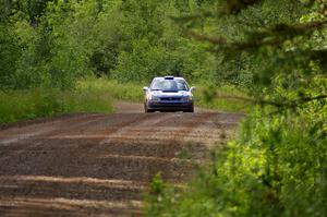 Mason Moyle / Scott Putnam at speed on a straight on SS2 in their Subaru Impreza.