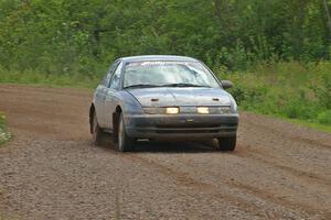 Dan Adamson / Chris Gordon drift their Saturn SL2 out of a fast sweeper on SS3.