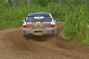 Mason Moyle / Scott Putnam drift their Subaru Impreza through a left-sweeper on SS3.