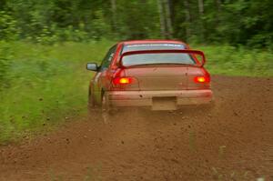 Dustin Kasten / Corina Soto drift beautifully through a sweeper on SS4 in their Subaru Impreza.