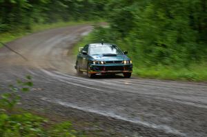 Janusz Topor / Michal Kaminski at speed in their Subaru Impreza out of a fast sweeper on SS5.