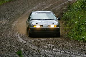 Dan Adamson / Chris Gordon drift their Saturn SL2 through a muddy downhill sweeper on SS5.