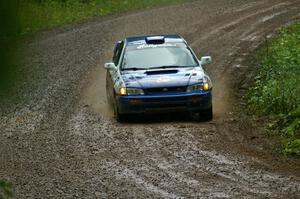 Mason Moyle / Scott Putnam slide their Subaru Impreza through a greasy downhill sweeper on SS5.