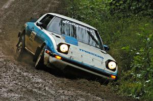 Doug Dill / Denny McGinn keep on the power and out of the ditch in their Mazda RX-7 on a greasy sweeper on SS5.