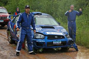 Carl Siegler / David Goodman guide their crew's truck backward to help get their Subaru WRX STi on the trailer.