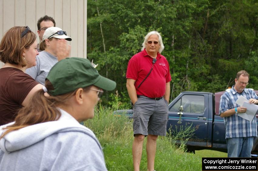 Kathy Freund expains things at the drivers meeting as Al Kintigh and Rob Bohn listen in.