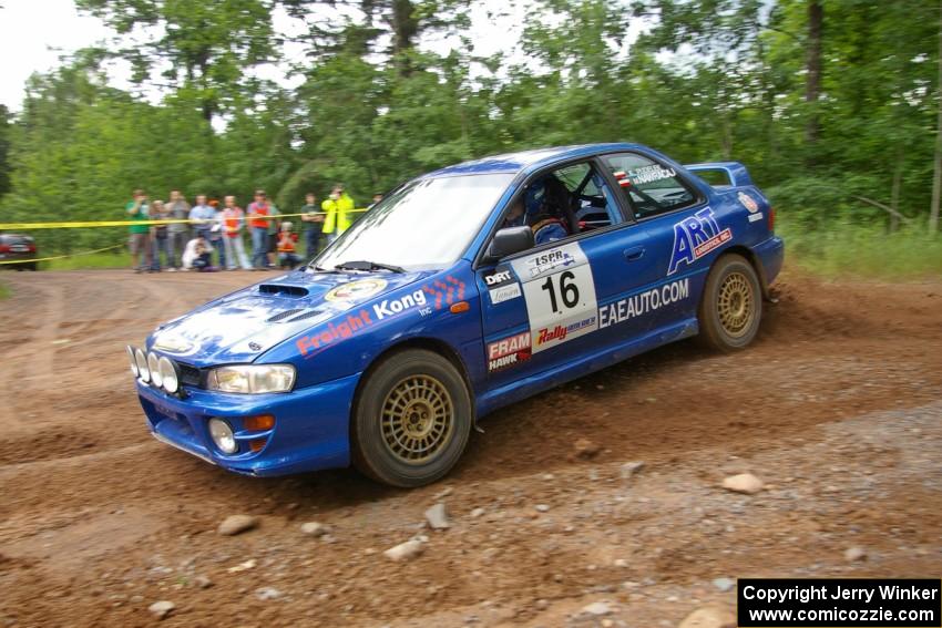 Kazimierz Pudelek / Michal Nawracaj take a hard left onto Potlatch Road in their Subaru Impreza on SS1.