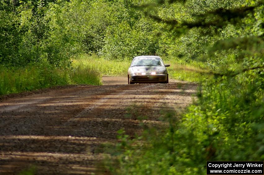 Dan Adamson / Chris Gordon at speed down a straight on SS2 in their Saturn SL2.