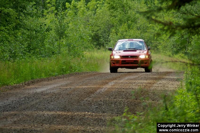 Dustin Kasten / Corina Soto at speed down a straight on SS2 in their Subaru Impreza.