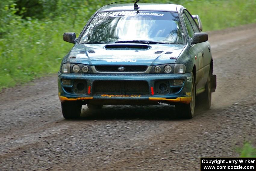 Janusz Topor / Michal Kaminski at speed down a straight on SS2 in their Subaru Impreza.