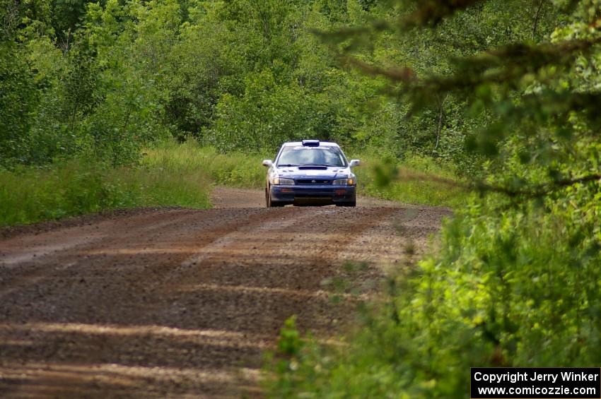 Mason Moyle / Scott Putnam at speed on a straight on SS2 in their Subaru Impreza.