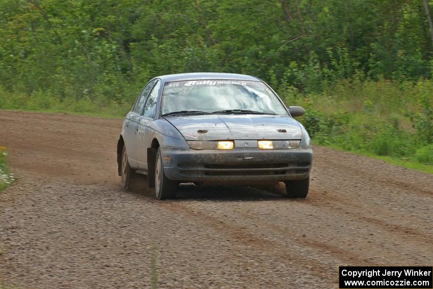 Dan Adamson / Chris Gordon drift their Saturn SL2 out of a fast sweeper on SS3.