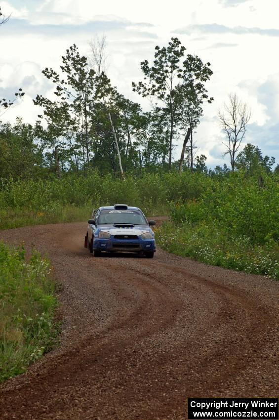 The Slawomir Balda / Piotr Boczek Subaru WRX through a S-curve on SS3 as the first raindrops start to fall.