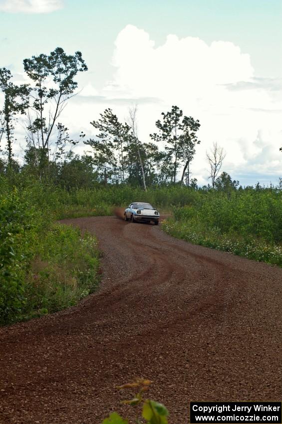 Doug Dill / Denny McGinn come through an S-curve in their Mazda RX-7 on SS3 as the rain increases.