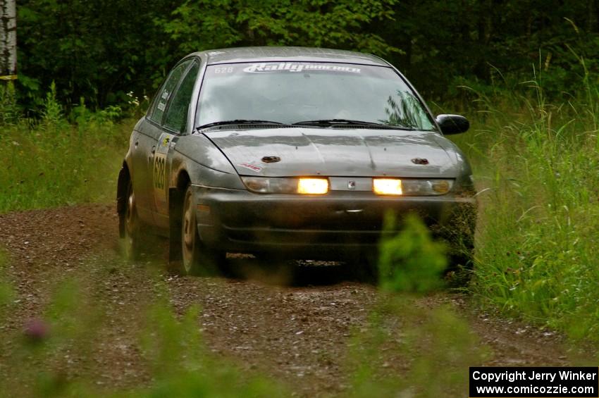 The Dan Adamson / Chris Gordon Saturn SL2 out of a left-sweeper at speed on SS4.