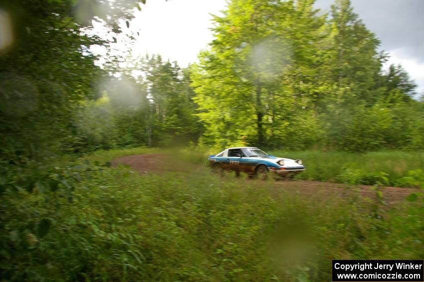 Doug Dill / Denny McGinn drift out of a sweeper on SS4 in their Mazda RX-7.