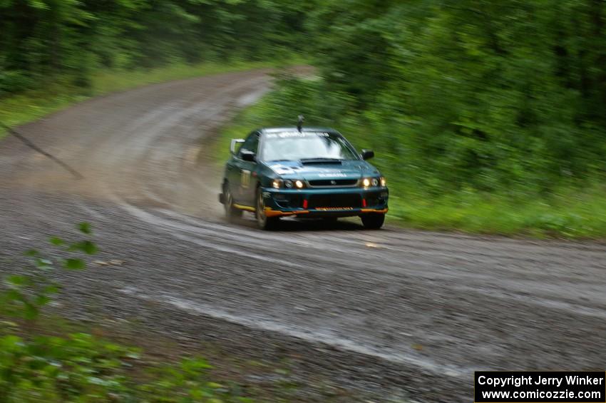 Janusz Topor / Michal Kaminski at speed in their Subaru Impreza out of a fast sweeper on SS5.