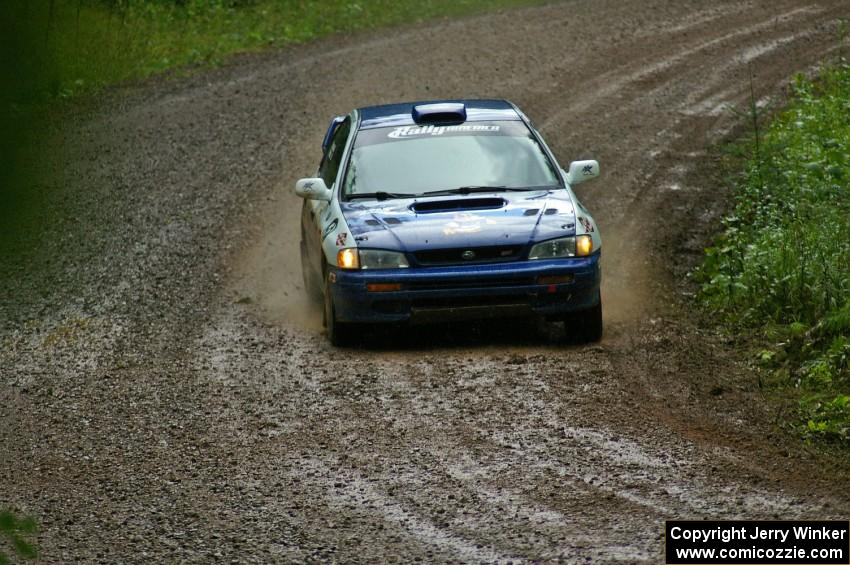 Mason Moyle / Scott Putnam slide their Subaru Impreza through a greasy downhill sweeper on SS5.