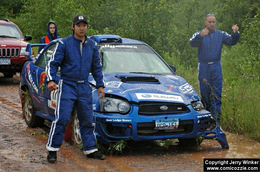 Carl Siegler / David Goodman guide their crew's truck backward to help get their Subaru WRX STi on the trailer.