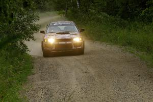 Bob Olson / Conrad Ketelsen in their Subaru Impreza drive up a gradual incline on the practice stage.