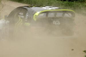 The Ken Block / Alex Gelsomino Subaru Impreza WRX STi spays gravel on the practice stage.