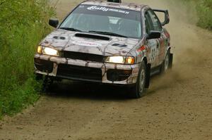 Bob Olson / Conrad Ketelsen hold a close apex on a right-hander on the practice stage in their Subaru Impreza.