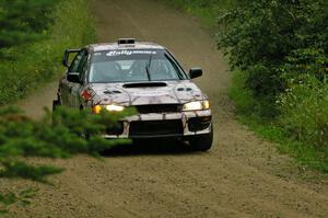 The Bob Olson / Conrad Ketelsen Subaru Impreza at speed on the practice stage.