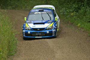 Travis Pastrana / Christian Edstrom set up and about to get back on the gas in their Subaru WRX STi on the practice stage.