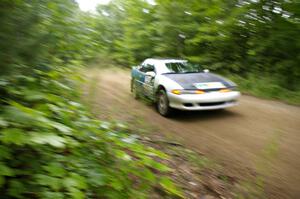Adam Markut / Chris Gordon at speed over a rise on the practice stage in their Eagle Talon.