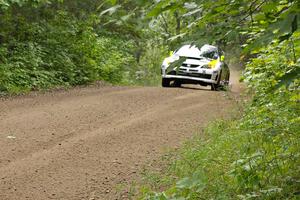 Ken Block / Alex Gelsomino come up over a rise in their Subaru Impreza WRX STi on the practice stage.