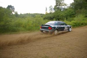 Chris Greenhouse / Don DeRose make a pair of rooster tails off the rear of their Plymouth Neon on the practice stage.