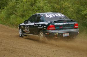 Chris Greenhouse / Don DeRose climb a small rise after a fast right hander in their Plymouth Neon on the practice stage.