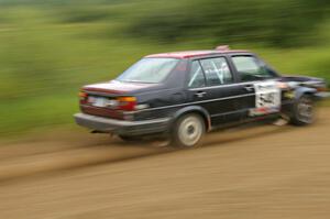 Matt Bushore / Kim DeMotte drift their VW Jetta out of a fast left hander on the practice stage.