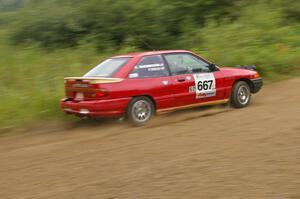 Paul Donlin / Elliot Sherwood slide through a left hander on the practice stage in their Ford Escort.