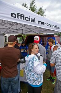 Emily Burton-Weinman takes care of the crowd of customers at the Rally-America Store tent.