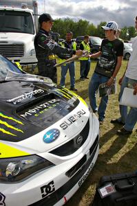 Ken Block signs autographs for fans in front of the Subaru WRX STi that he and navigator Alex Gelsomino shared.