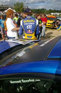 Travis Pastrana signs autographs for fans in front of the Subaru WRX STi that he and navigator Christian Edstrom shared.