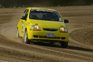 Jim Stevens / Marianne Stevens take their Suzuki Swift along the high bank on SS1.