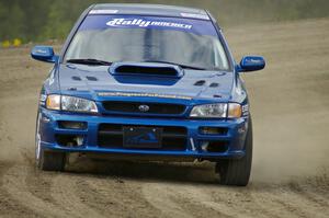 Piotr Fetela / Mariusz Malik slide their Subaru Impreza on the high bank on SS1.