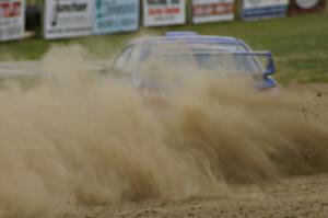 Janusz Topor / Michal Kaminski blast gravel coming off the high bank on SS1 in their Subaru WRX STi.