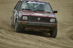 Matt Bushore / Kim DeMotte drift their VW Jetta on the high bank on SS1.